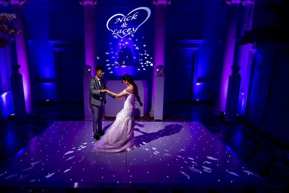 A couple dancing on a white starlit dance floor supplied by Just Dance Floors